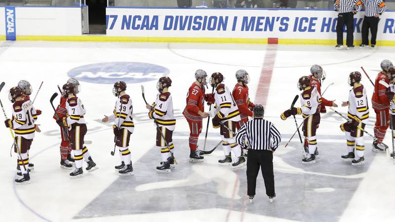 The Minnesota-Duluth and the Ohio State teams shake hands after their overtime of an NCAA West...