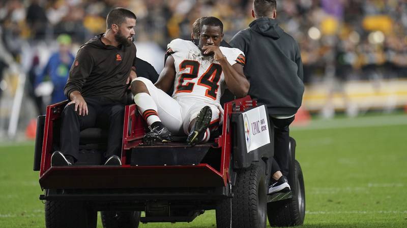 Cleveland Browns running back Nick Chubb is cared off the field with an injury during the first...